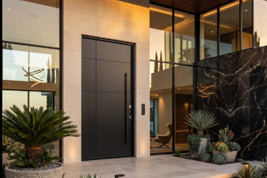 Entryway - large modern marble floor entryway idea in Miami with beige walls and a dark wood front door