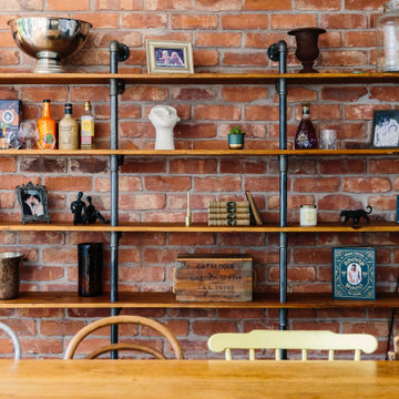 A fun and eclectic dining room with industrial shelving