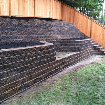 Homeowner had no room, installed 2 terraces of block walls & a fire pit too