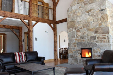 Living room - large rustic formal and open concept medium tone wood floor and brown floor living room idea in Providence with white walls, a standard fireplace and a stone fireplace