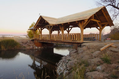 Design ideas for a large craftsman full sun hillside landscaping in Denver with decking.