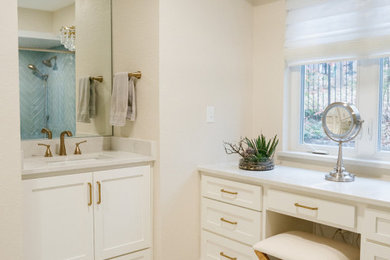 Bathroom - mid-sized transitional master blue tile and ceramic tile marble floor, white floor and double-sink bathroom idea in Dallas with raised-panel cabinets, white cabinets, a one-piece toilet, white walls, an undermount sink, solid surface countertops, a hinged shower door, white countertops and a built-in vanity