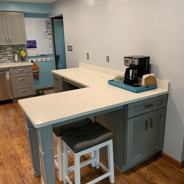 kitchen remodel--gray cabinets with white quartz and new splash