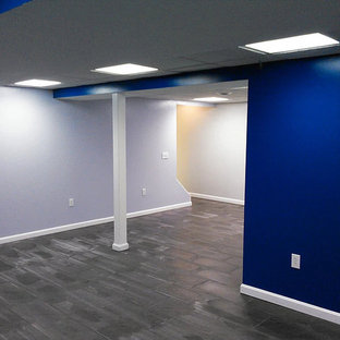 Photo of a medium sized contemporary fully buried basement in Cleveland with blue walls, slate flooring, no fireplace and grey floors.
