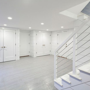 Design ideas for a medium sized nautical walk-out basement in Boston with white walls, grey floors, slate flooring and no fireplace.