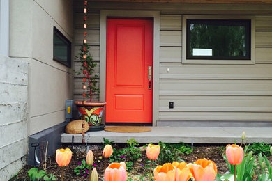 Single front door - mid-sized eclectic single front door idea in Other with a red front door