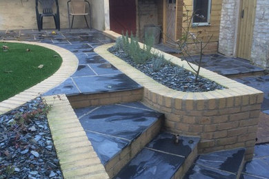Design ideas for a medium sized contemporary back formal partial sun garden for summer in Cornwall with brick paving.