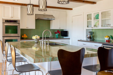 This is an example of a large contemporary l-shaped open plan kitchen in Los Angeles with an undermount sink, recessed-panel cabinets, white cabinets, quartzite benchtops, green splashback, terra-cotta splashback, stainless steel appliances, medium hardwood floors and with island.