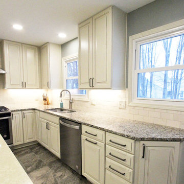 Beige Kitchen with Extra Large Island, Tile Backsplash and Granite Countertops