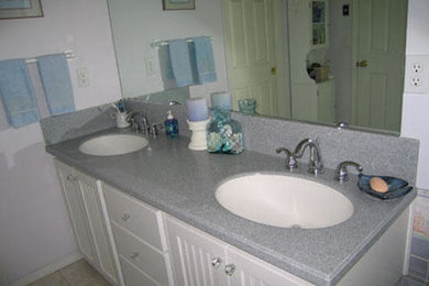 Example of a transitional beige tile bathroom design in Portland with white cabinets and white walls
