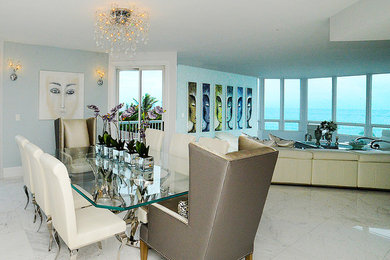 Large contemporary open plan dining in Miami with blue walls, marble floors and no fireplace.