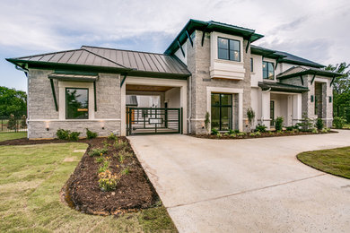 Inspiration for a large contemporary beige two-story mixed siding exterior home remodel in Dallas with a metal roof