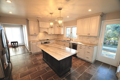 Inspiration for a mid-sized transitional l-shaped black floor open concept kitchen remodel in Miami with an integrated sink, ceramic backsplash, an island and beige countertops