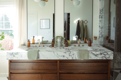 Example of a mid-sized transitional master ceramic tile, multicolored floor and double-sink bathroom design in Other with flat-panel cabinets, medium tone wood cabinets, white walls, an undermount sink, quartz countertops, a hinged shower door, white countertops and a floating vanity