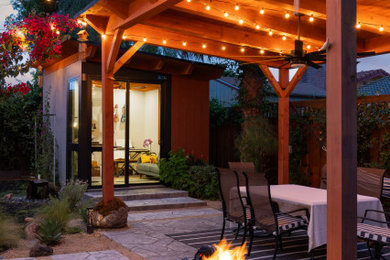 Small contemporary gray one-story stucco and board and batten house exterior idea in San Francisco with a shed roof, a mixed material roof and a white roof