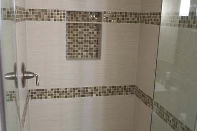 Inspiration for a small contemporary 3/4 multicolored tile and glass tile porcelain tile alcove shower remodel in Orange County with an undermount sink, furniture-like cabinets, white cabinets, quartz countertops, a one-piece toilet and beige walls