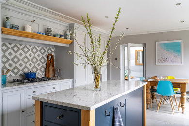 Example of a mid-sized trendy porcelain tile open concept kitchen design in Other with a farmhouse sink, shaker cabinets, granite countertops, stainless steel appliances and an island