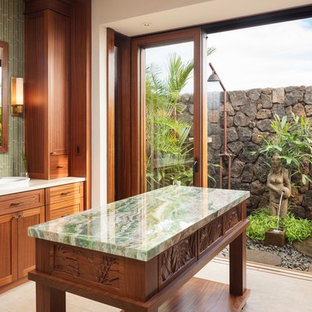 Bathroom - tropical green tile beige floor bathroom idea in Hawaii with shaker cabinets, medium tone wood cabinets, white walls, a drop-in sink and green countertops