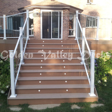 azek deck with big stiar and glass panel railing