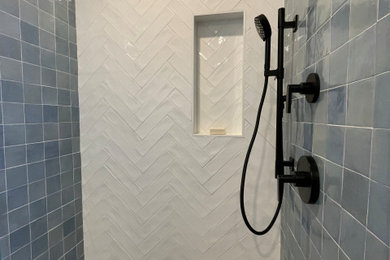 Example of a small transitional 3/4 blue tile and porcelain tile porcelain tile, gray floor and single-sink alcove shower design in San Francisco with shaker cabinets, white cabinets, a bidet, white walls, an undermount sink, marble countertops, a hinged shower door, gray countertops, a niche and a freestanding vanity