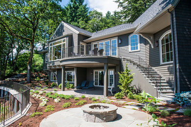 Inspiration for a mid-sized transitional gray two-story mixed siding gable roof remodel in Portland