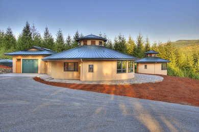 Mid-sized minimalist yellow one-story stucco exterior home photo in Other