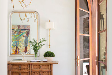 Mid-sized transitional medium tone wood floor and brown floor entryway photo in Little Rock with white walls and a medium wood front door
