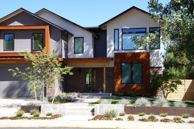 Design ideas for a mid-sized modern drought-tolerant and full sun front yard concrete paver and wood fence retaining wall landscape in Denver.