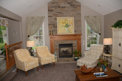 Example of a mid-sized farmhouse open concept carpeted living room design in Other with gray walls, a standard fireplace, a stone fireplace and a concealed tv