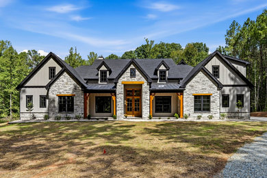 Inspiration for a large farmhouse gray two-story concrete fiberboard and board and batten exterior home remodel in Raleigh with a shingle roof and a gray roof