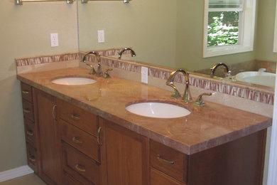 Alcove shower - mid-sized transitional 3/4 ceramic tile alcove shower idea in Portland with recessed-panel cabinets, dark wood cabinets, gray walls, an undermount sink and soapstone countertops