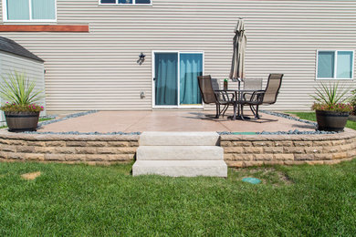 Photo of a small backyard retaining wall landscape in Minneapolis.