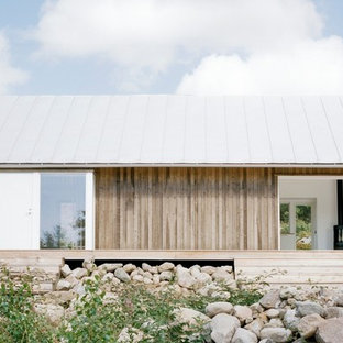Example of a mid-sized danish beige one-story wood exterior home design in Stockholm