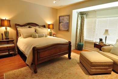 Inspiration for a mid-sized traditional master bedroom in Omaha with beige walls, medium hardwood floors and no fireplace.