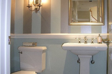 Example of a mid-sized 3/4 ceramic tile bathroom design in New York with a drop-in sink, a one-piece toilet and multicolored walls