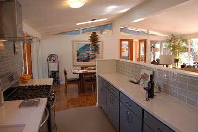 Mid-sized trendy galley beige floor enclosed kitchen photo in San Francisco with an undermount sink, beaded inset cabinets, gray cabinets, quartz countertops, gray backsplash, glass tile backsplash, stainless steel appliances and no island