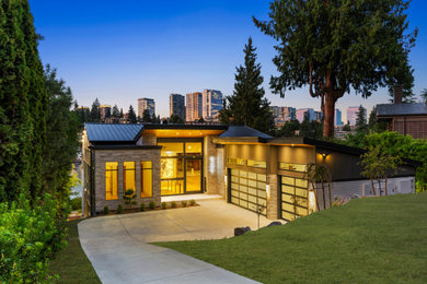 Example of a large trendy gray two-story stone and clapboard house exterior design in Seattle with a metal roof and a black roof