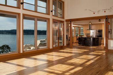 Design ideas for a large contemporary open concept living room in Seattle with white walls and light hardwood floors.