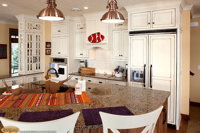 Eat-in kitchen - coastal l-shaped eat-in kitchen idea in Other with an undermount sink, beaded inset cabinets, distressed cabinets, quartz countertops, white backsplash, mosaic tile backsplash and paneled appliances