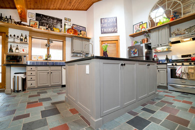 Large transitional l-shaped separate kitchen in New York with an undermount sink, raised-panel cabinets, grey cabinets, granite benchtops, blue splashback, ceramic splashback, stainless steel appliances, slate floors, with island and multi-coloured floor.