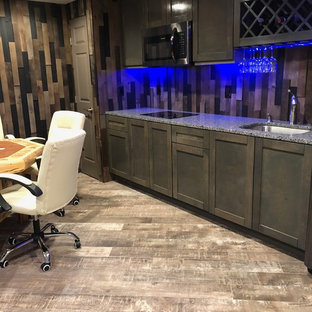 This is an example of a medium sized rustic fully buried basement in Baltimore with brown walls, porcelain flooring, no fireplace and grey floors.