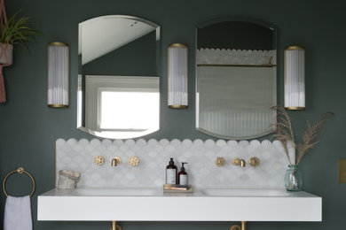 Design ideas for a mid-sized eclectic master bathroom in Kent with a freestanding tub, an open shower, a wall-mount toilet, green walls, marble floors, solid surface benchtops, an open shower, white benchtops, a niche, a double vanity, a floating vanity and vaulted.