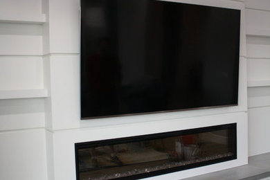 Inspiration for a large contemporary open concept gray floor living room remodel in Phoenix with white walls, a standard fireplace, a concrete fireplace and a wall-mounted tv
