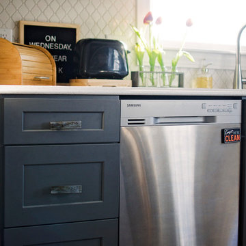 Timberwood glass knobs and pulls freshen up this grey galley kitchen.