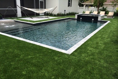 Trendy backyard rectangular hot tub photo in Miami