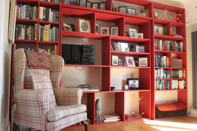 This is an example of a large modern home office in Essex with a reading nook and beige walls.