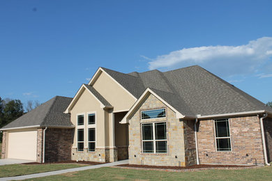 Mid-sized contemporary brown one-story stone exterior home idea in Dallas with a clipped gable roof