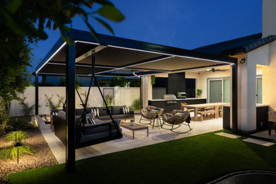 Example of a mid-sized transitional backyard stone patio kitchen design in Phoenix with a gazebo