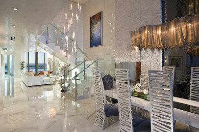 Large contemporary formal open concept living room in Miami with white walls and marble floors.