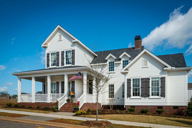 Large arts and crafts white two-story concrete fiberboard exterior home photo in Other with a clipped gable roof
